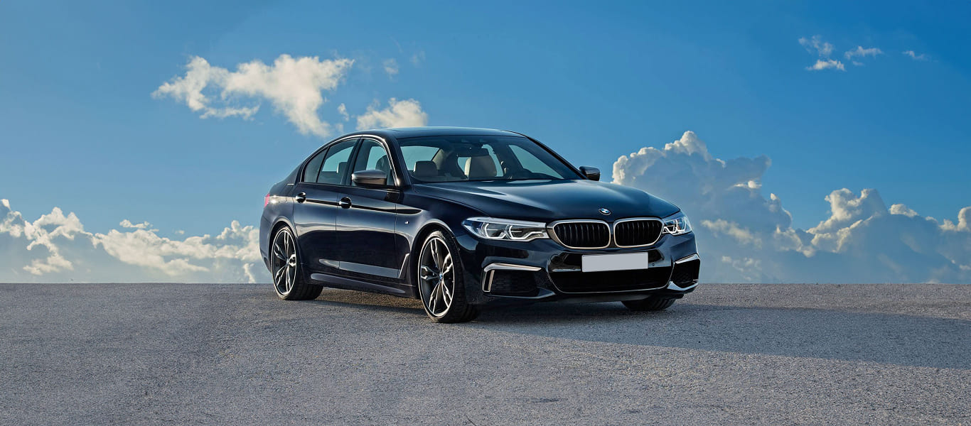 Front-facing shot with signature kidney grille and LED headlights.