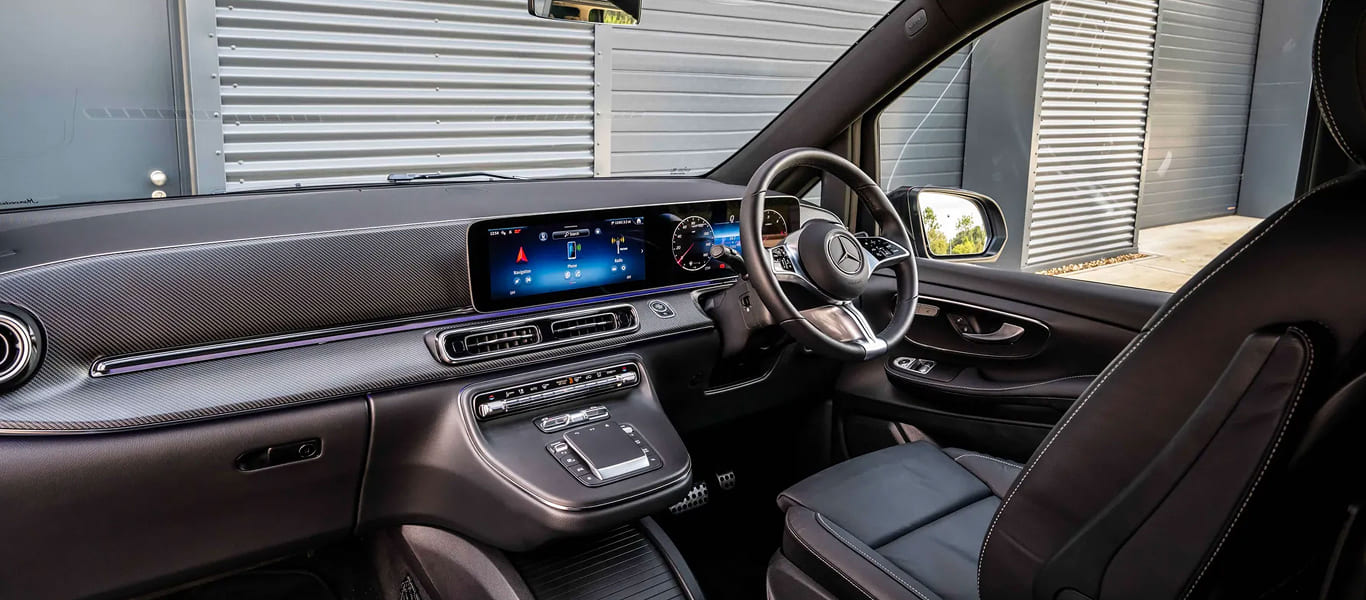 Side profile with tinted privacy windows and multi-passenger capacity.